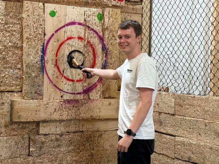 Photograph of Dylan with an axe.